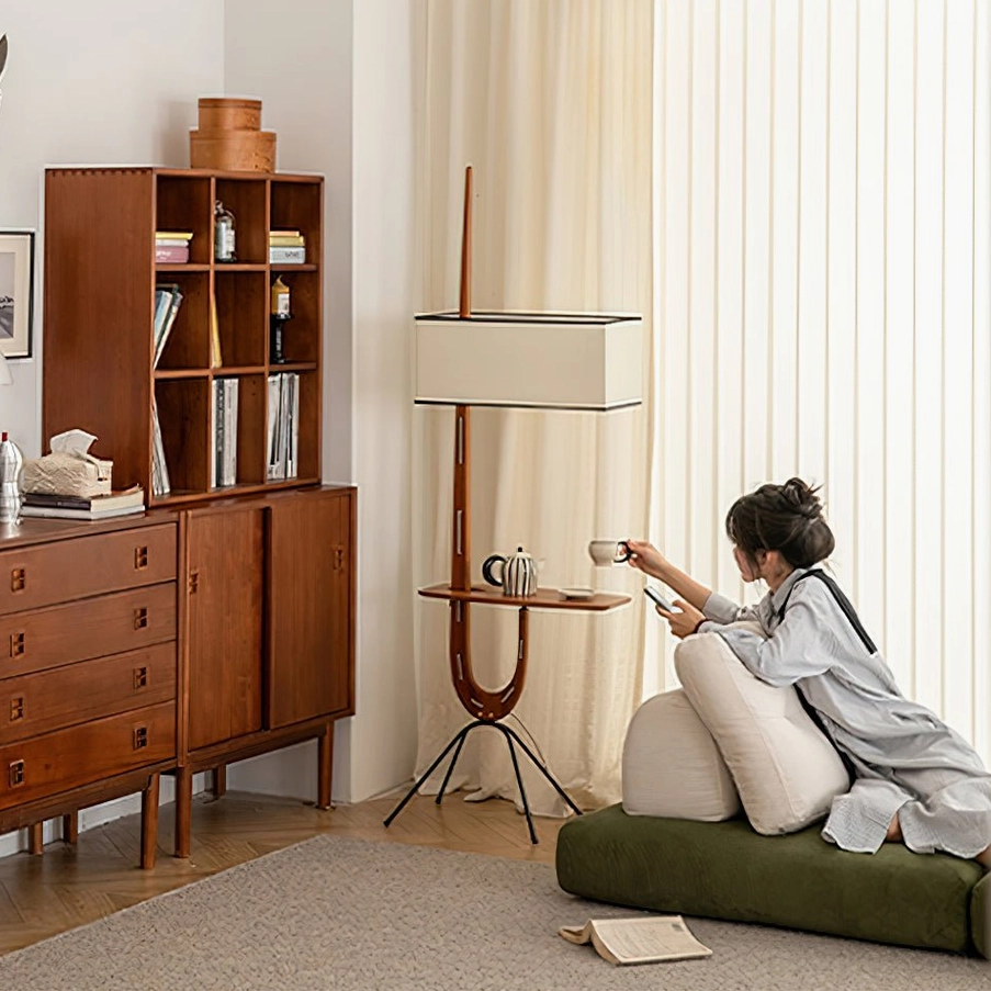 Black modern wood floor lamp with integrated side shelf in contemporary home office space