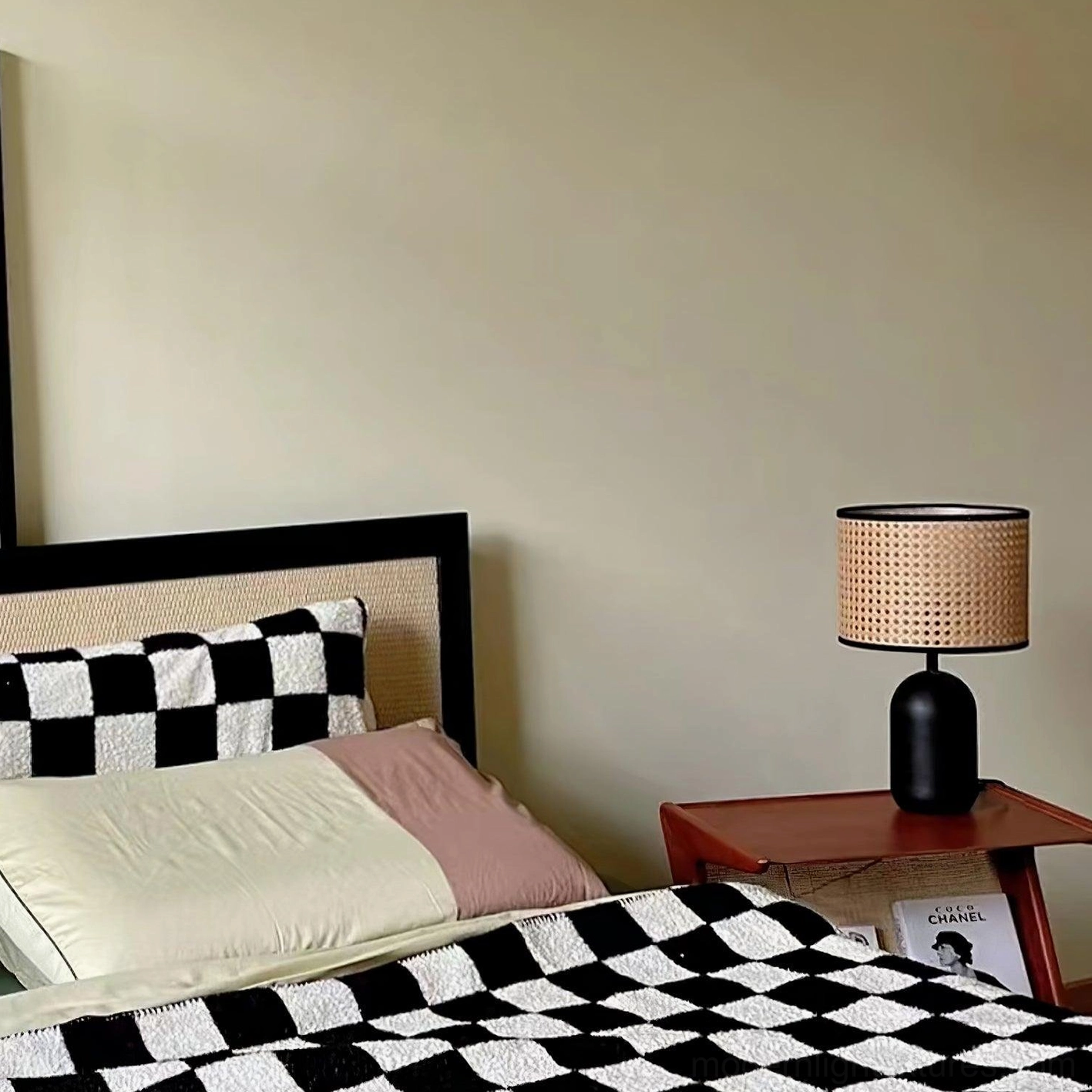 Blakely table lamp beside checkered bedding in modern minimalist bedroom setting