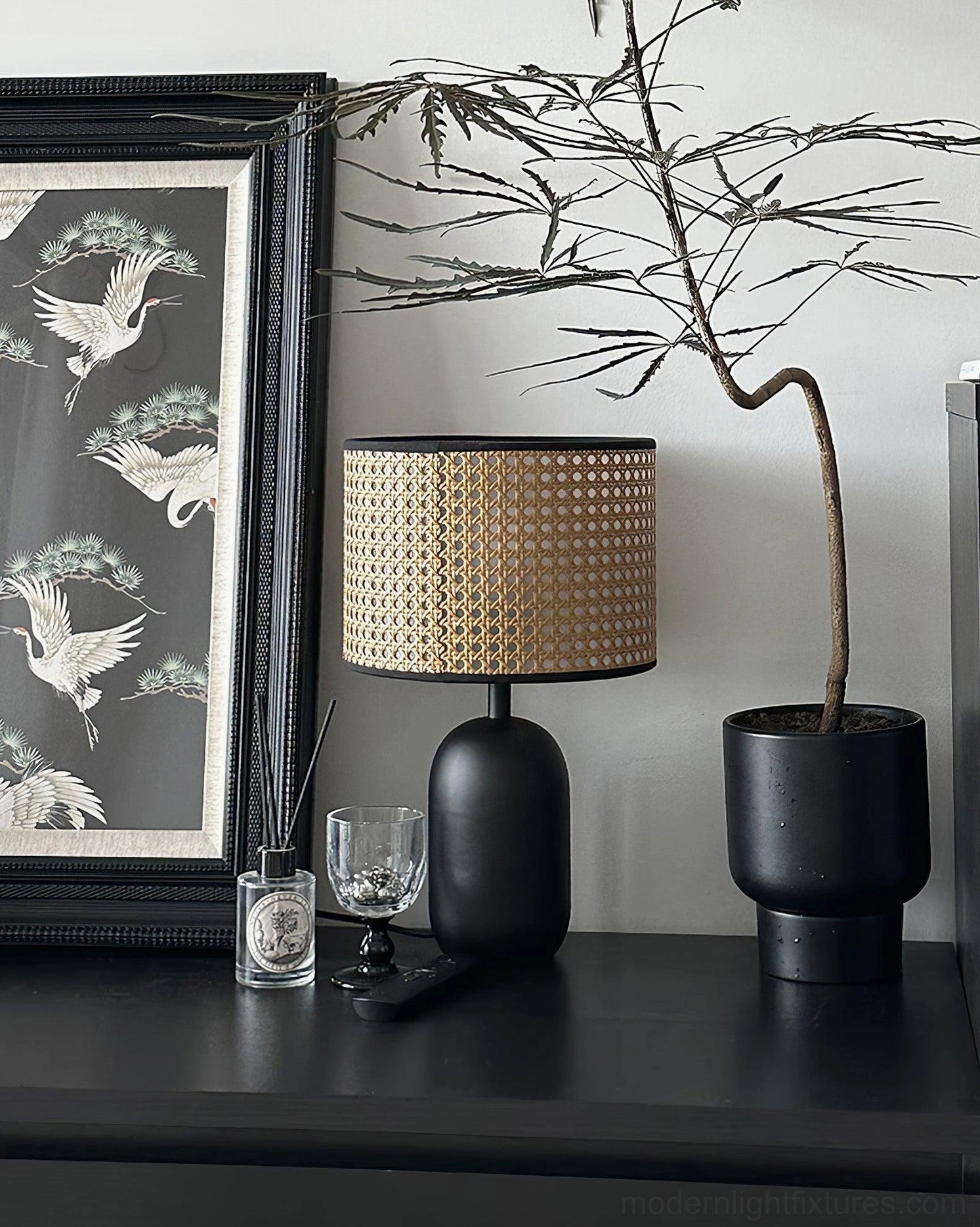 Blakely lamp showcasing matte black metal base with natural rattan shade contrast