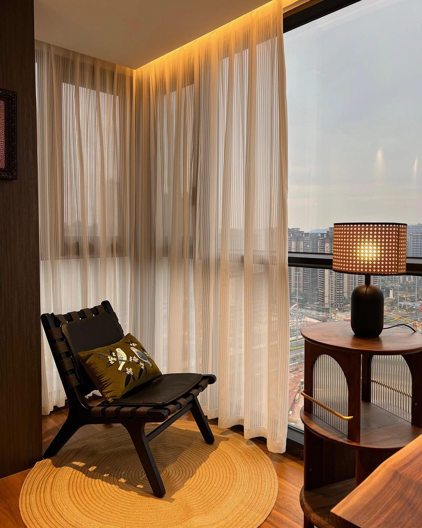 Blakely woven rattan lamp paired with brass accents and natural wood surfaces