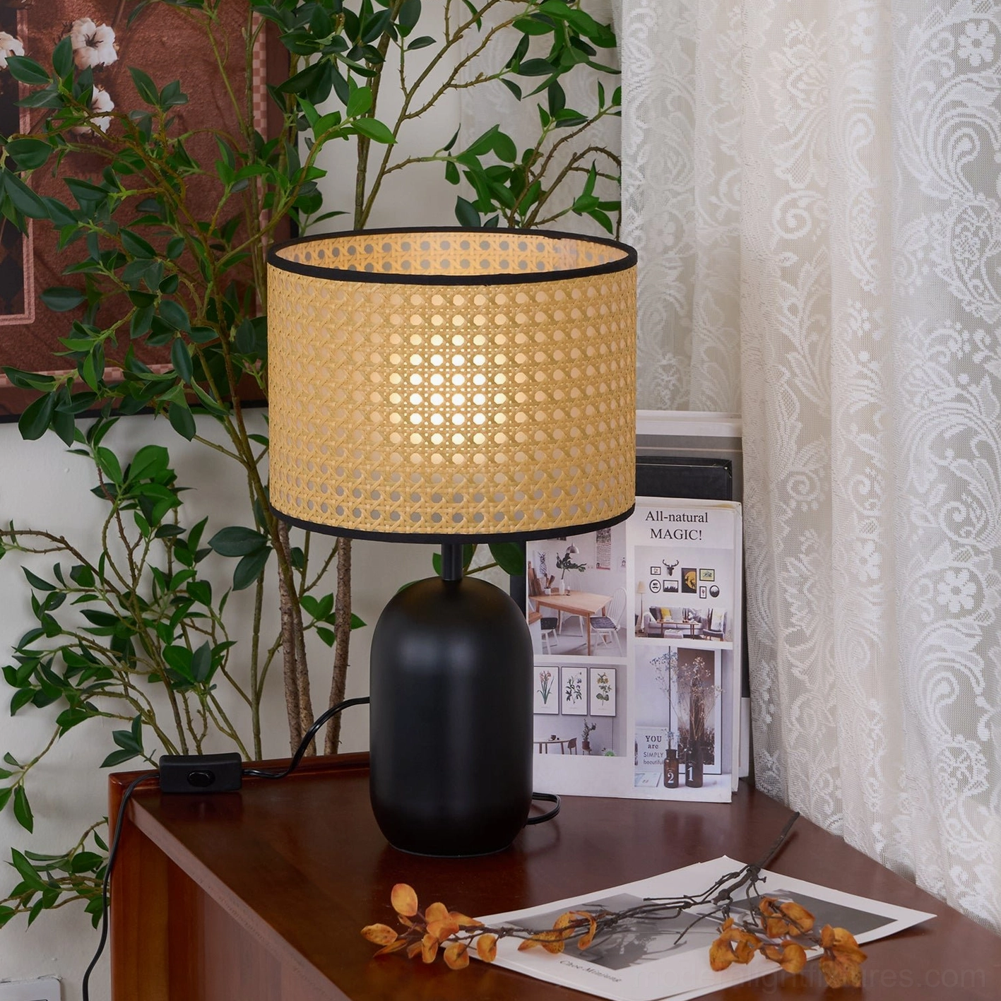 Blakely rattan lamp three-quarter view on bedroom dresser with dried flowers and magazine decor
