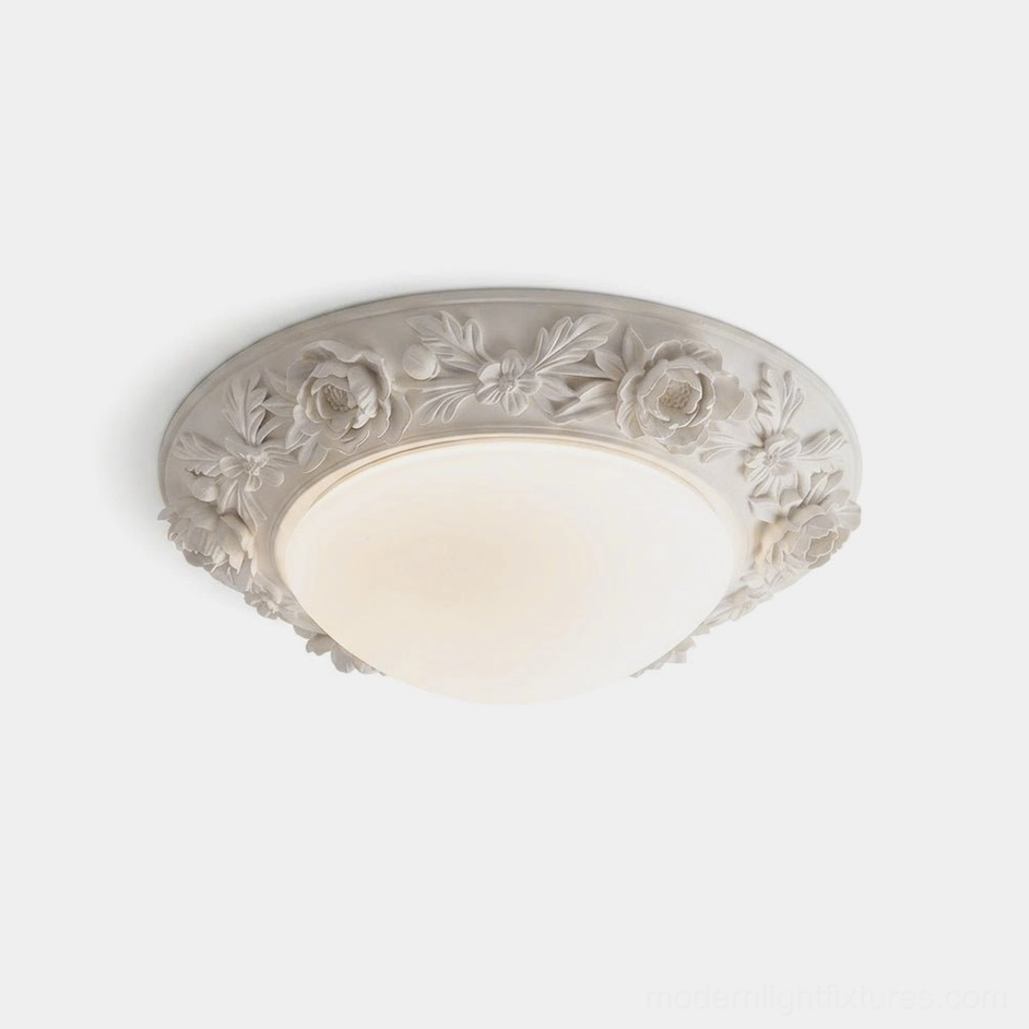 Blancora hand-carved floral flush mount ceiling light with frosted glass dome and warm white integrated LED, close-up studio view