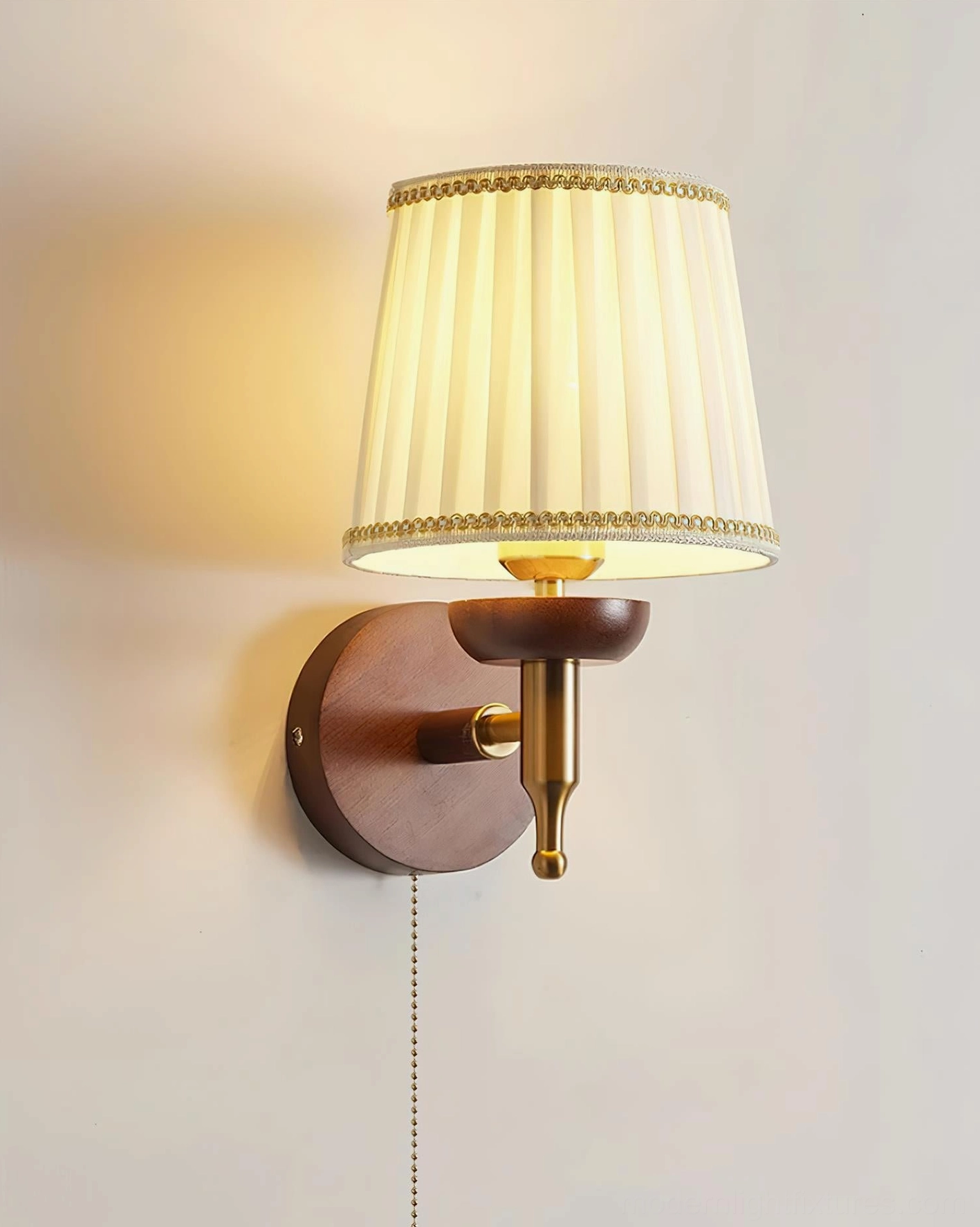 Blixen pleated fabric wall lamp front close-up on neutral wall backdrop