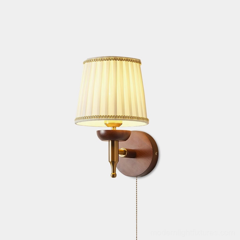 Blixen pleated fabric wall sconce with walnut wood base and brass arm - front studio view