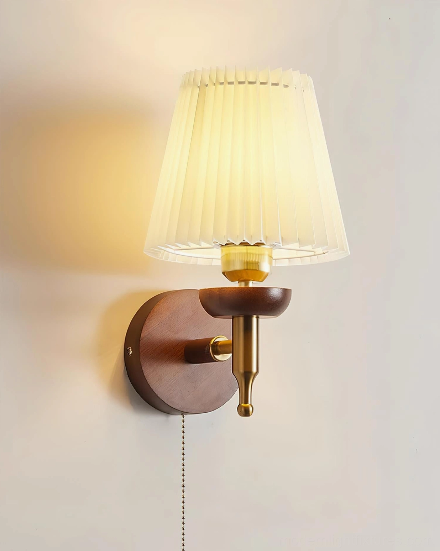 Blixen wall sconce mounted on bedroom accent wall for bedside reading light
