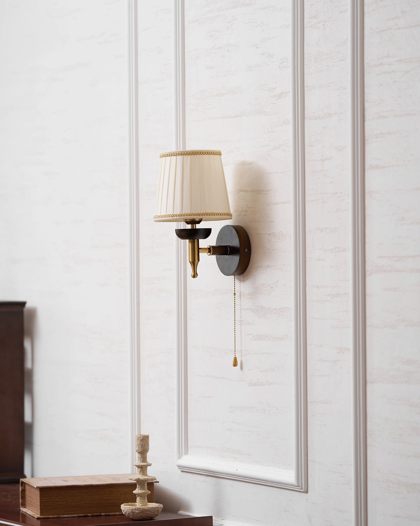 Blixen wall sconce available in multiple colors including beige and gold options