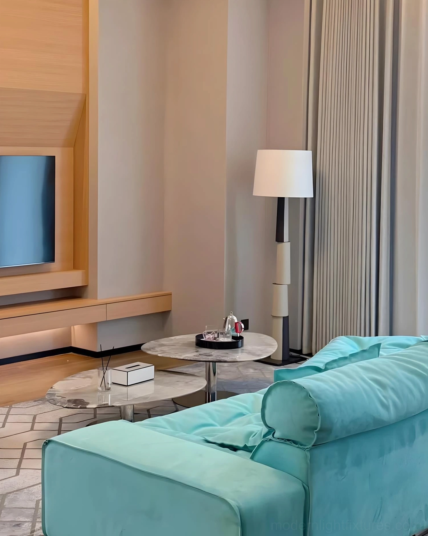 Modern block floor lamp next to turquoise velvet sofa in bright contemporary living room - geometric minimalist design