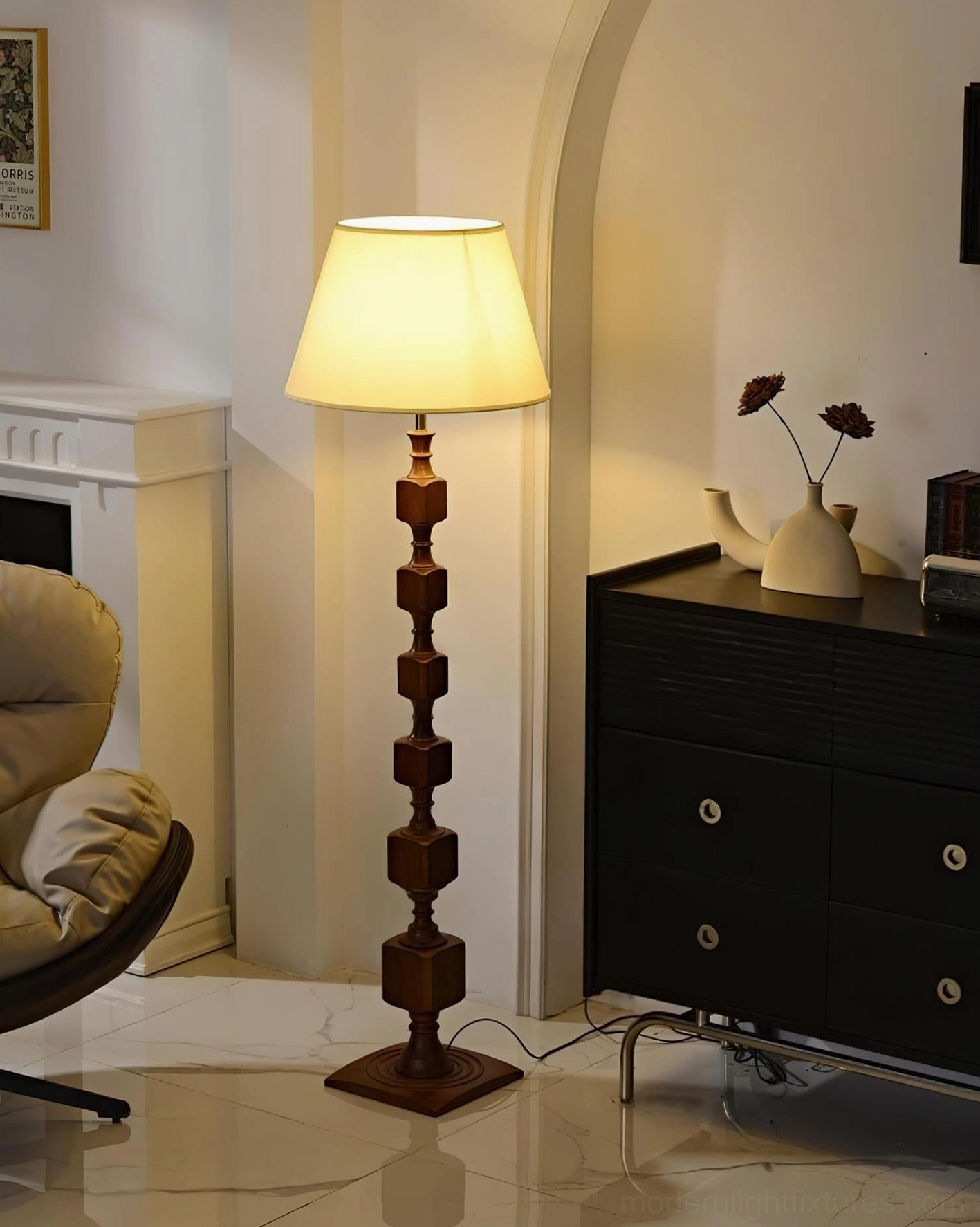 Walnut-finish Blockora floor lamp with beige fabric shade creating warm ambient lighting in cozy lounge seating area, intimate reading space
