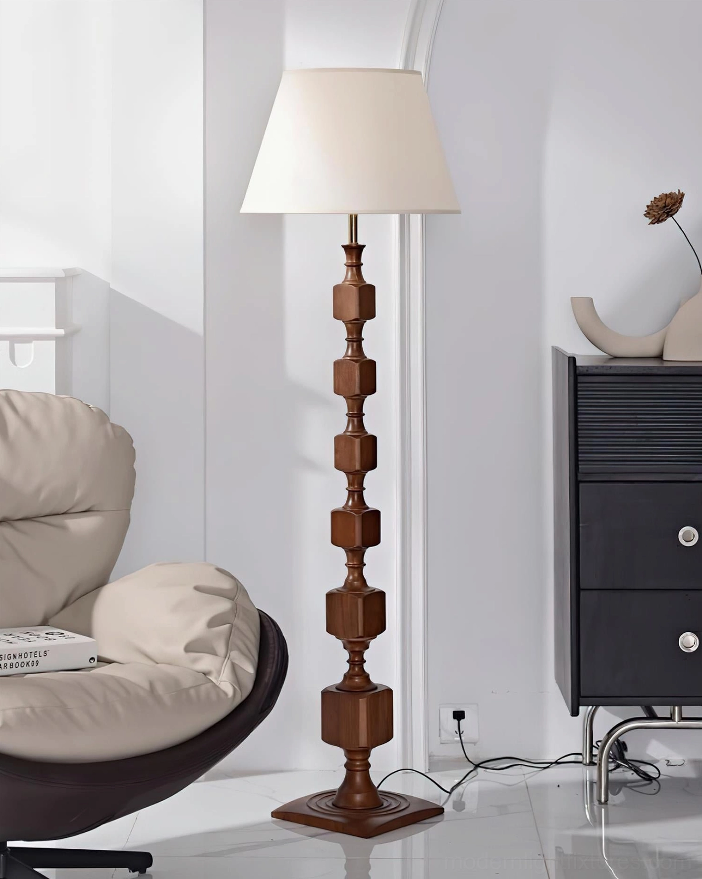 Walnut Blockora stacked floor lamp with white fabric shade in modern living room corner beside lounge seating and contemporary decor
