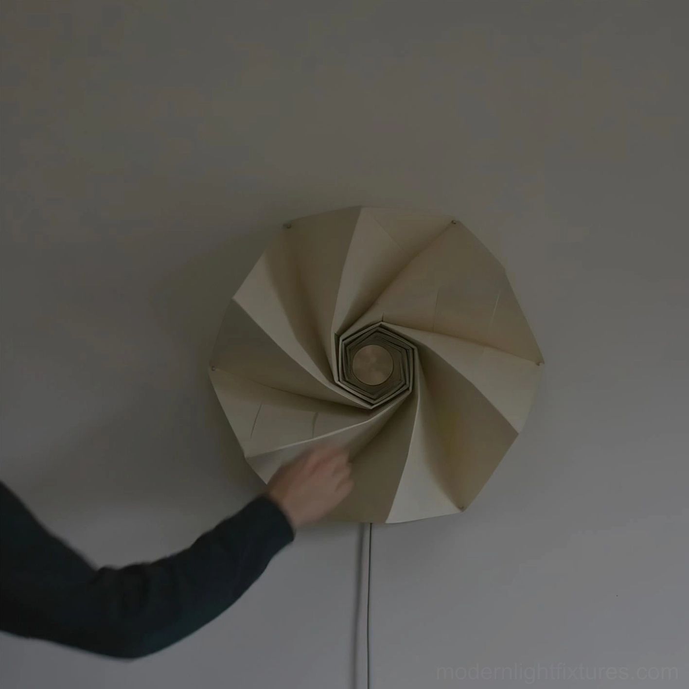 Bloom modern wall lamp illuminated detail showing multi-layered origami-inspired folded design with warm light