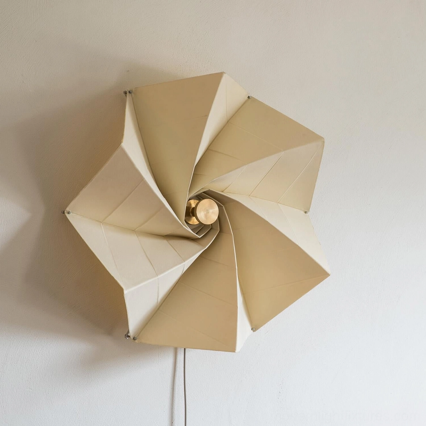 Bloom sculptural wall sconce unlit showing matte beige fabric finish and metal body construction