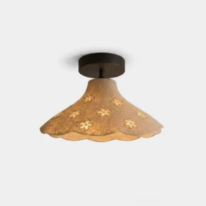 Bloomira floral flush mount ceiling light with scalloped beige resin shade featuring hand-carved flower cutouts and solid copper black base, front studio view
