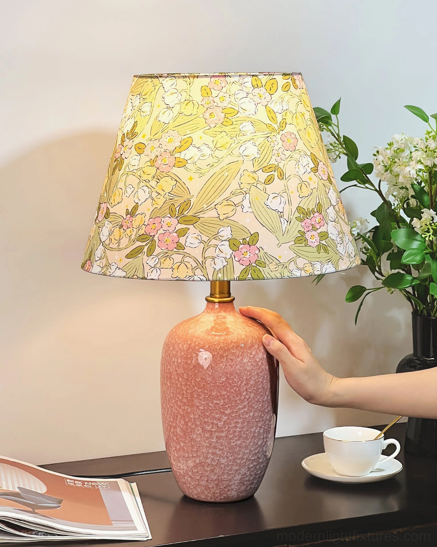 Bloomora ceramic table lamp creating warm ambient lighting in bedroom setting with nightstand styling