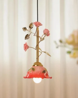 Close-up detail of Bloomvelle pendant showing hand-finished ceramic roses and gold-tone leaves on brass stem