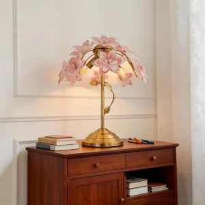 Pink glass flower table lamp on wooden dresser in retro vintage interior bedroom setting