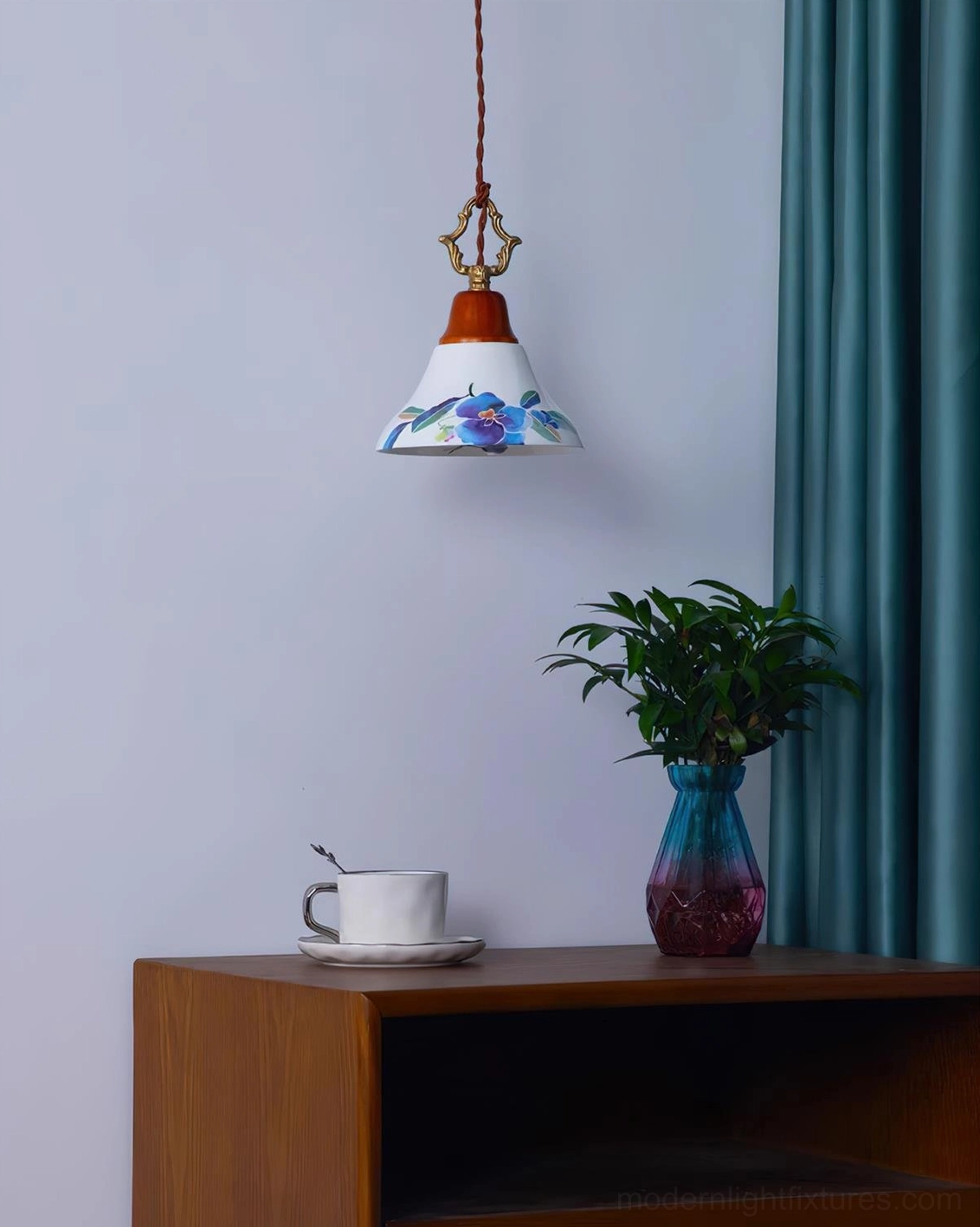 Illuminated blue azalea pendant lamp in cozy interior setting with side table, coffee cup and potted plant, soft warm glow