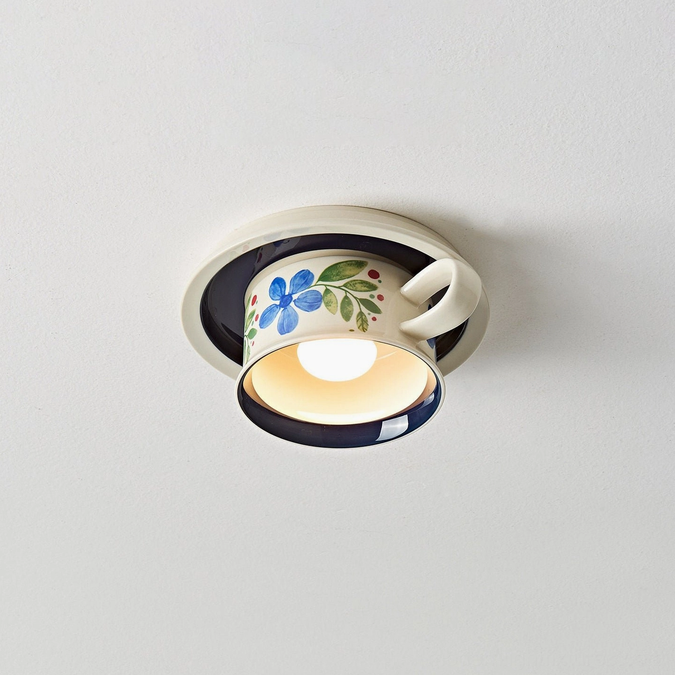 Blue ceramic hand-painted tea cup ceiling fixture front view with floral details and teacup silhouette