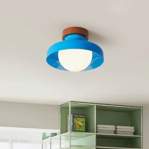 Blue modern ceiling light fixture installed in minimalist residential study with open shelving and ambient illumination
