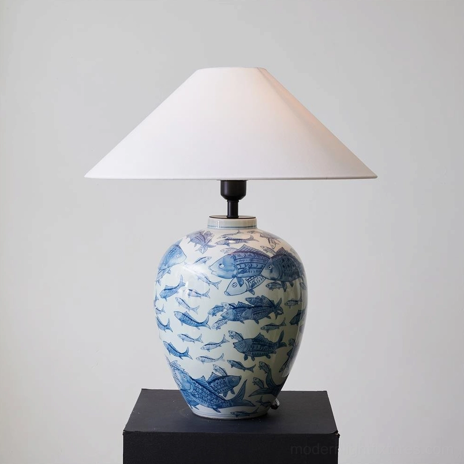 Blue and white ceramic table lamp with hand-painted fish patterns, showing socket type and electrical assembly details
