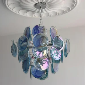Blue iridescent glass disc chandelier mounted on ceiling with decorative medallion, showing layered glass disc composition