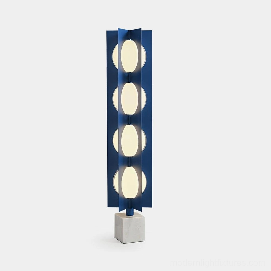Blue glass floor lamp with 4 illuminated spheres and white marble base, front view on white background