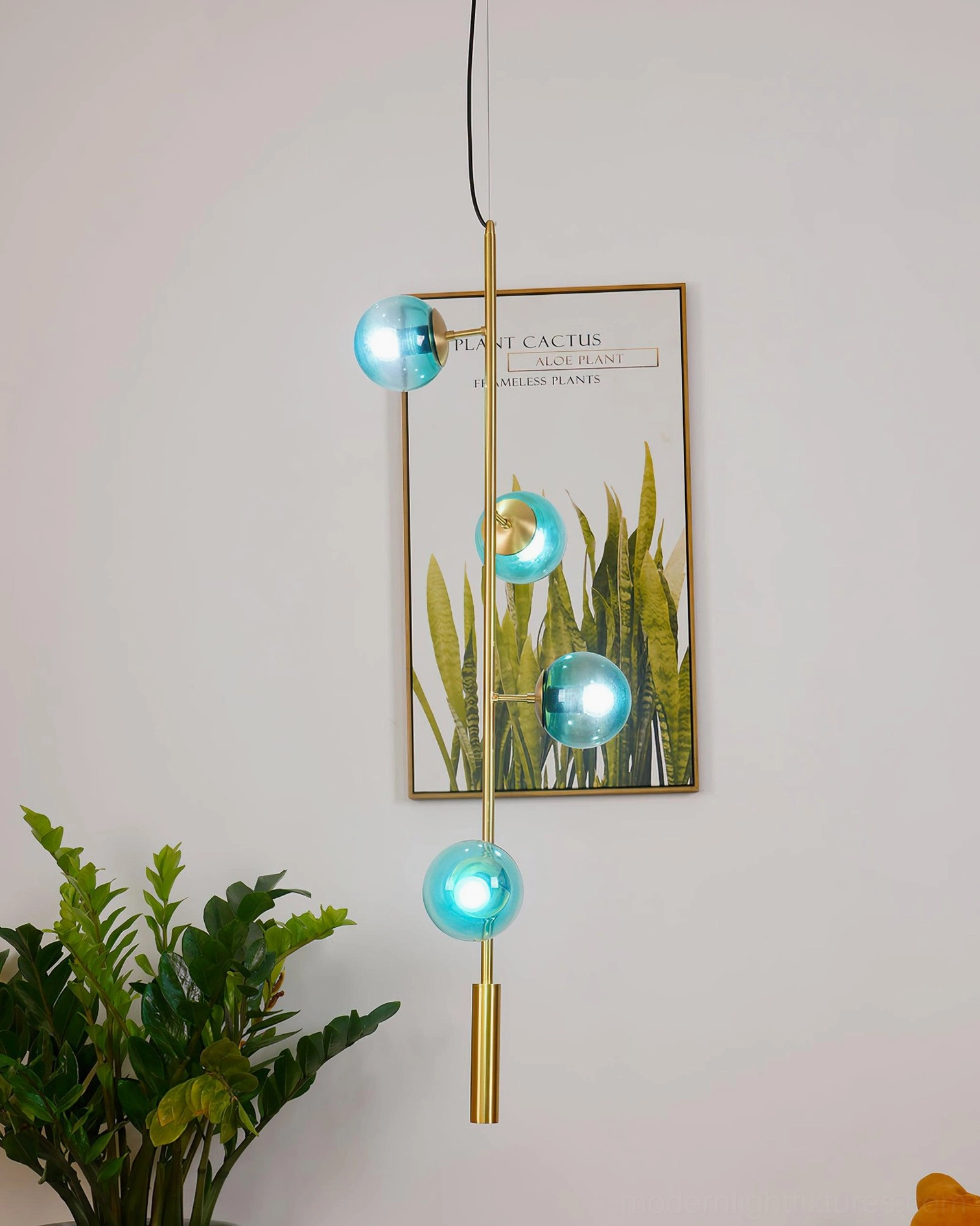 Contemporary blue glass orb pendant chandelier in modern minimalist home entryway