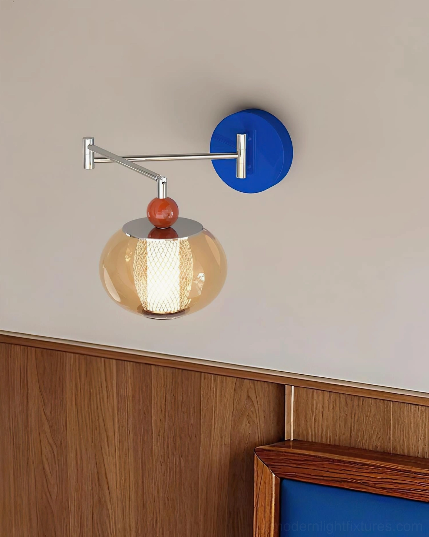 Blue Gyro wall lamp mounted on bedroom headboard with curved metal swing arm
