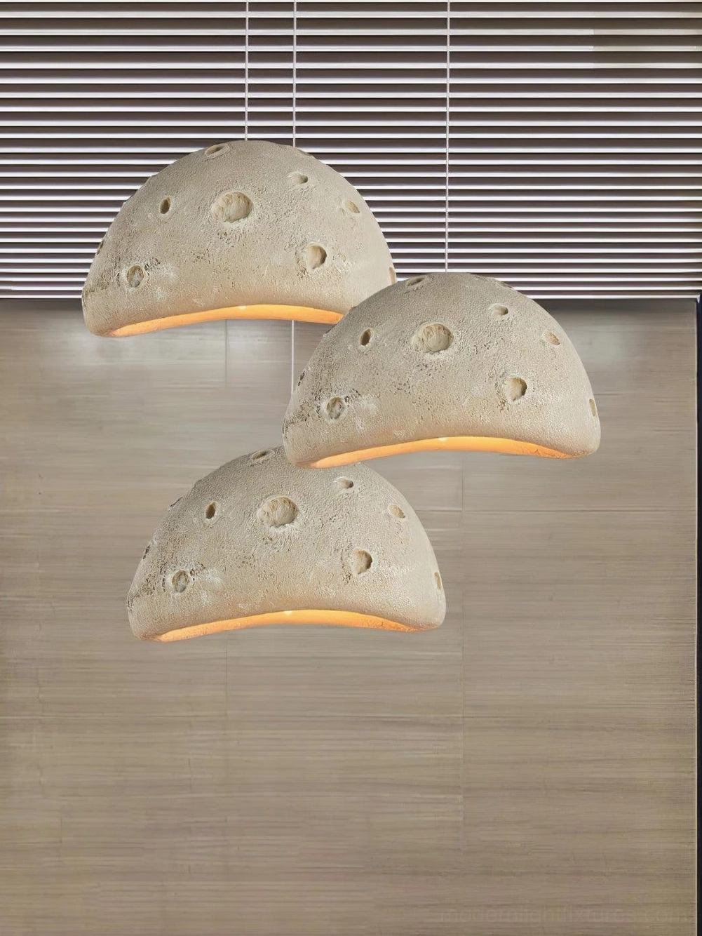 Blue meteorite crater pendant light paired with modern lounge furniture and wall art installation