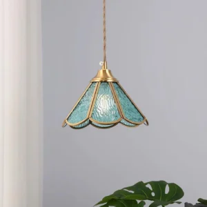 Blue scalloped glass pendant lamp overhead view showing textured rippled surface and brass trim in home setting