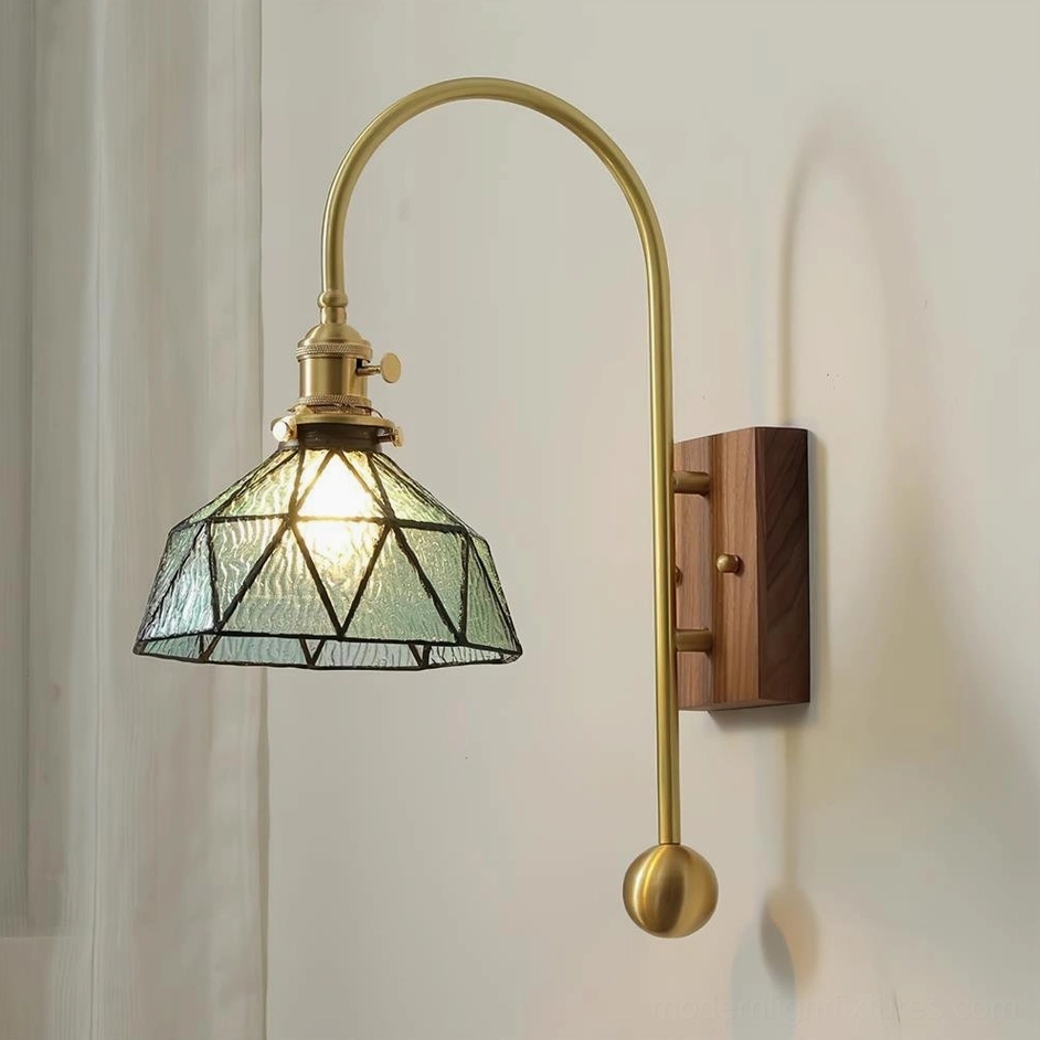 Deep blue stained glass wall sconce with brass arm and walnut mounting base