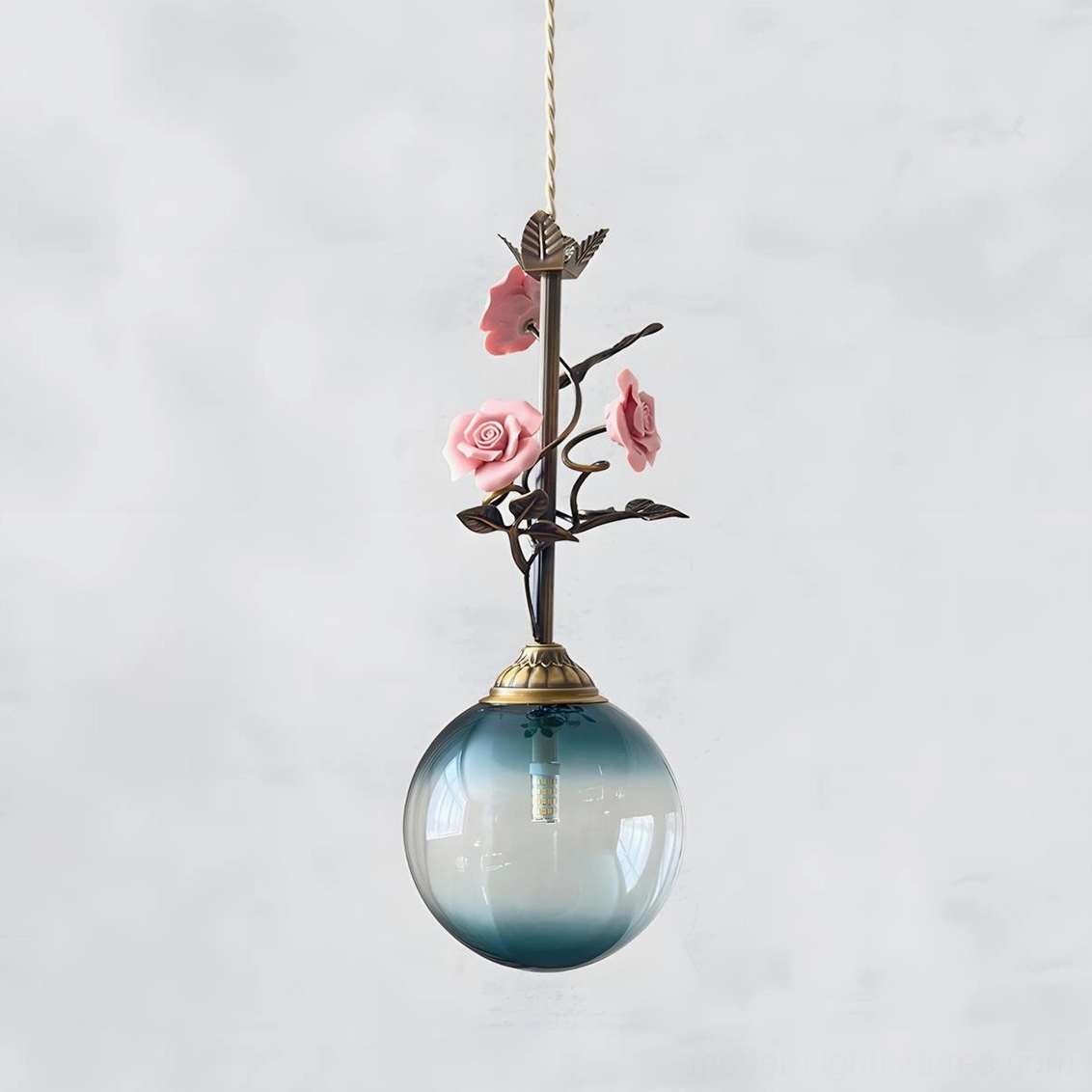 Blue tinted floral pendant light with hand-formed rose stem, artistic glass shade