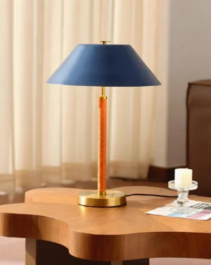 Blue volume table lamp styled on wooden side table in contemporary living room setting