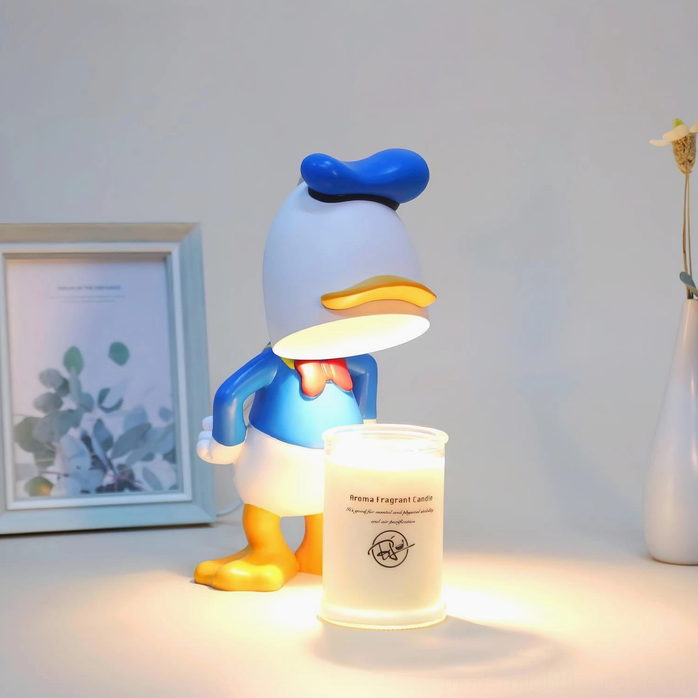 Blue and white character candle warmer lamp on decorative shelf display with complementary home accessories and warm glow ambiance