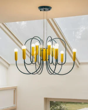 Blue metal chandelier with yellow bulbs in minimalist duplex room with skylight