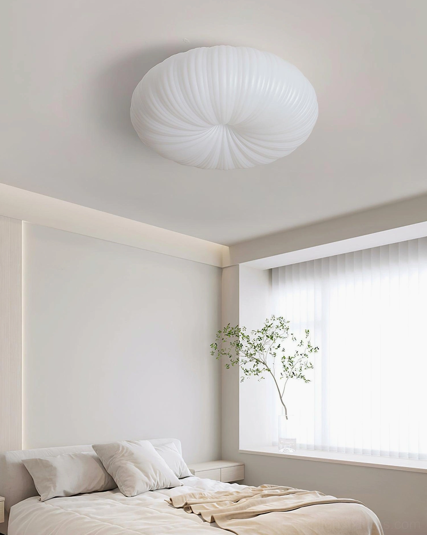 Bobby ceiling light in bright bedroom with side window, cream pleated fixture above simple neutral bedding