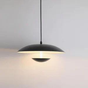 Boden black aluminum pendant fixture with dual-layer design and warm ambient lighting underneath, front studio shot