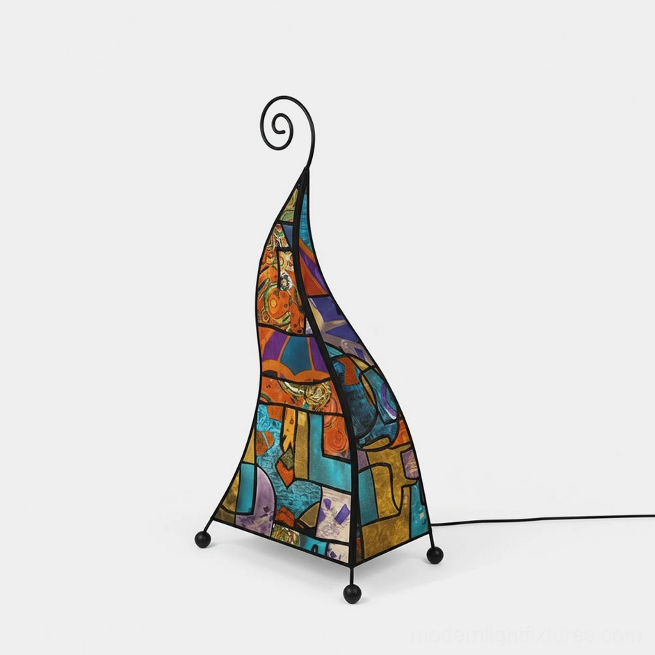 Bohemian floor lamp with curled black metal frame and colorful mosaic patterned fabric shade on white studio background