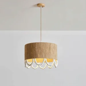 Natural hemp rope pendant light with wooden beaded trim hanging from ceiling mount, neutral studio backdrop