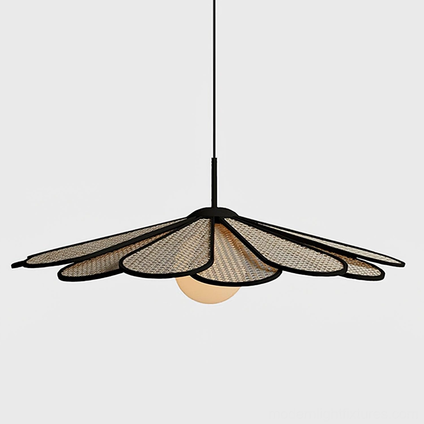 Three-quarter view of woven rattan pendant lamp showing sculptural flower-petal design in residential setting