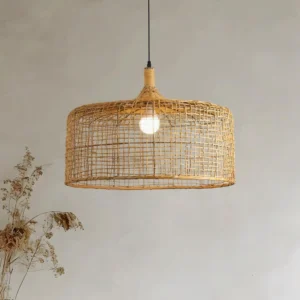 Bohemian rattan pendant light hung in minimalist interior space with dried floral decor, warm ambient lighting effect
