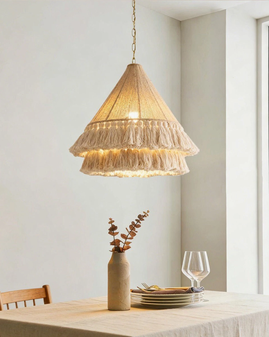 Bohemira bohemian pendant light hanging over dining table in modern farmhouse interior with warm white lighting and natural textures