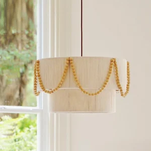 Boho drum pendant light with polished wood beads, three-quarter side angle showing weave texture and natural bead detail