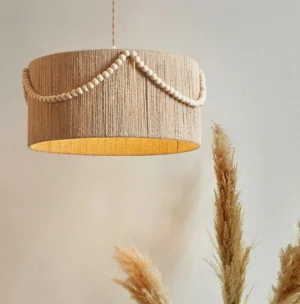 Boho hemp rope pendant lamp low-angle close-up with pampas grass decor, showing woven texture detail