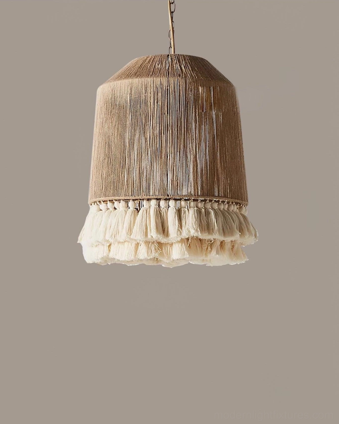 Boho tassel pendant light fixture illuminated showcasing warm glow through woven shade