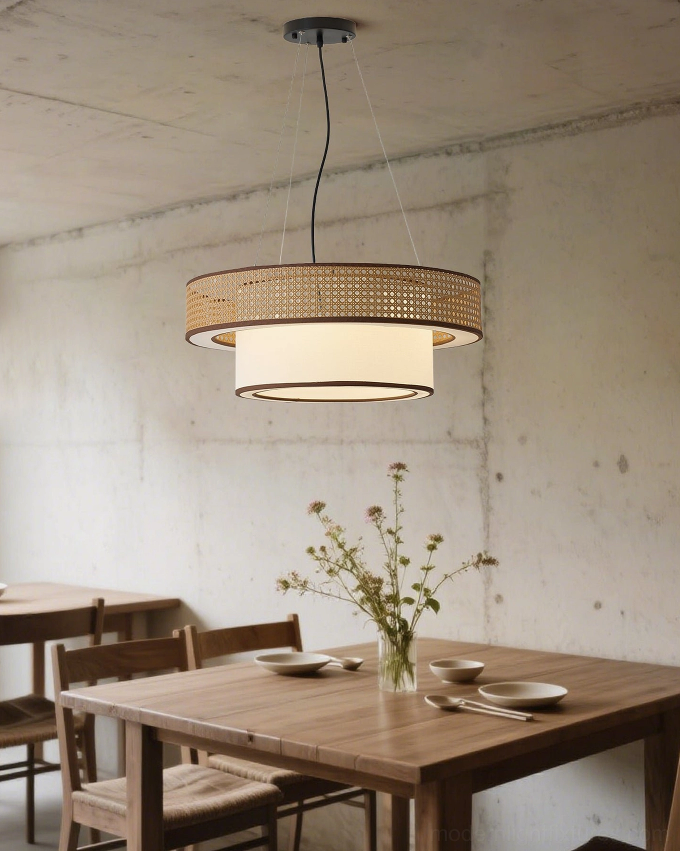 Natural rattan woven pendant light with white fabric shade in casual dining space, creating intimate warm atmosphere for family gatherings