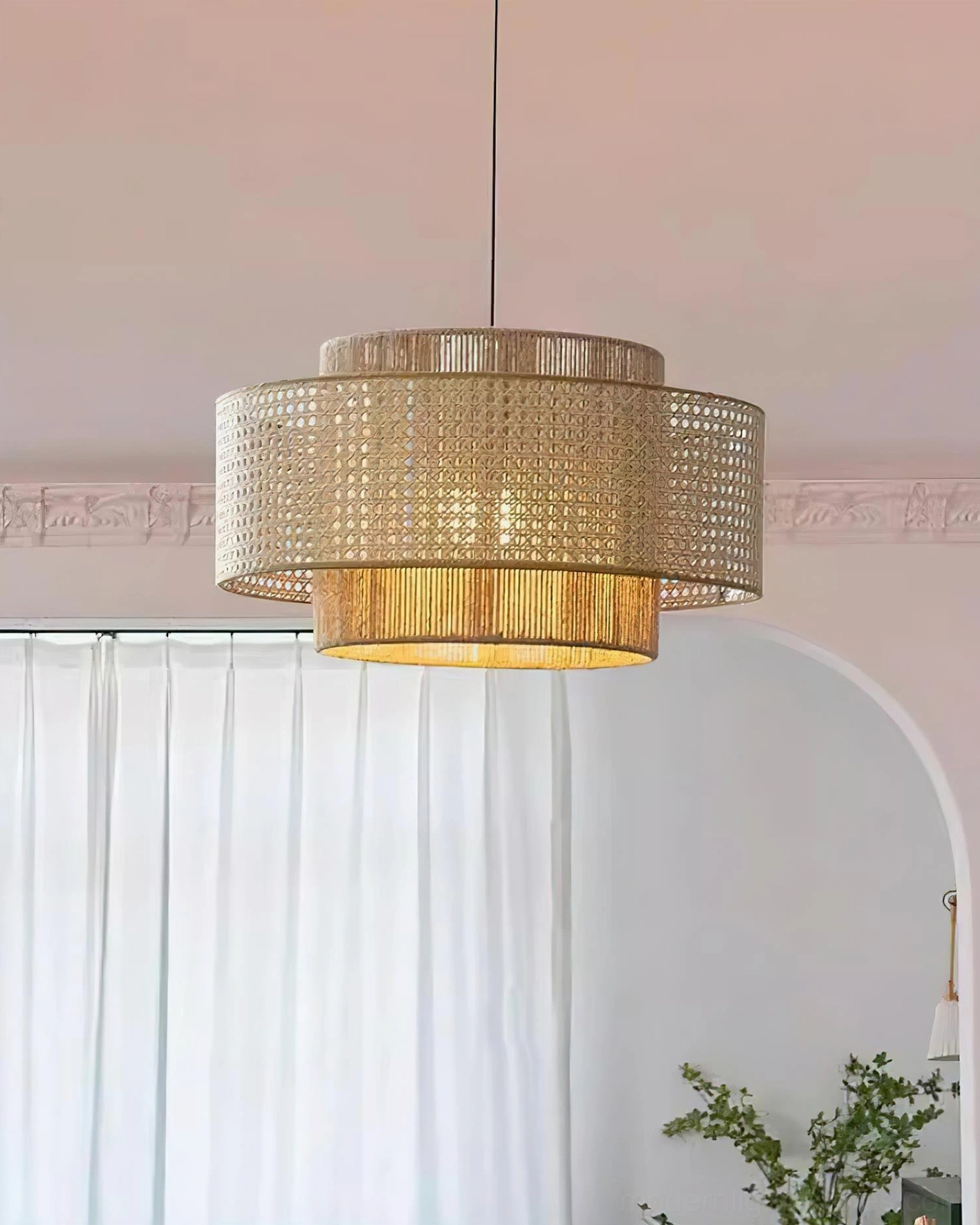 Boho rattan pendant light installed above dining area, demonstrating proper suspension height and ambient lighting atmosphere