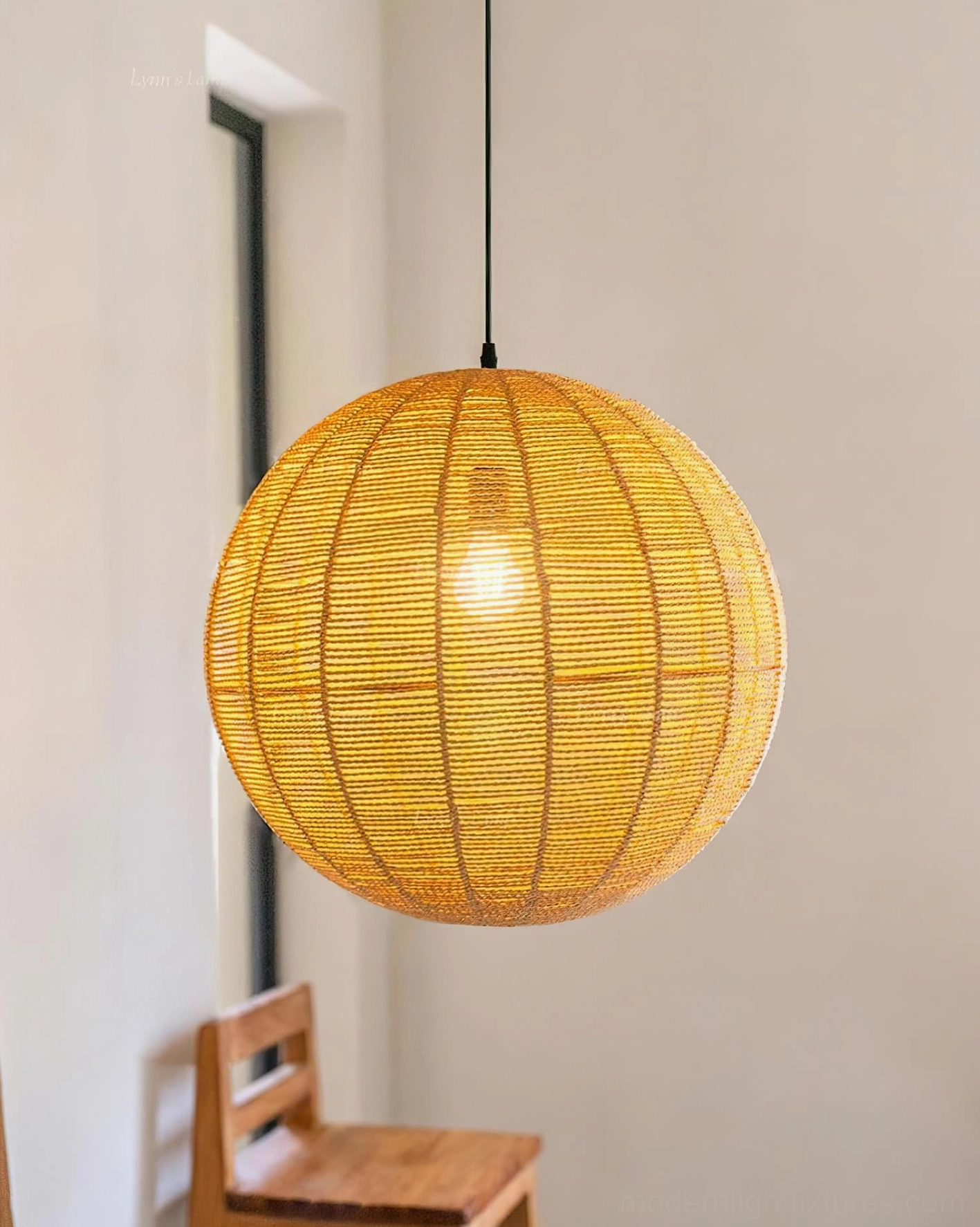 Glowing rattan pendant light in modern bohemian living room with window view