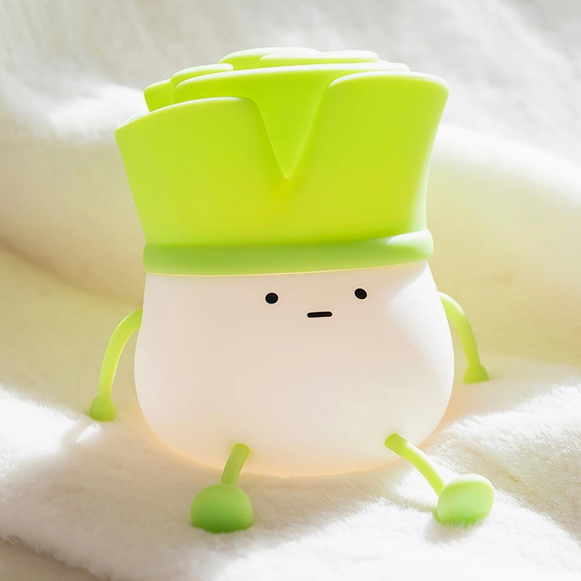 Cute bok choy night light with warm glow on plush fabric close-up