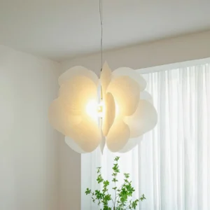 Bolide illuminated pendant light in bright living room - warm white glow through translucent acrylic petals