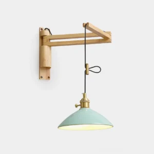 Boreal adjustable swing arm wall sconce with natural wood frame, brass hardware, and mint green ceramic conical shade in studio setting